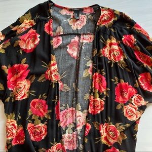 Lightweight, flowy, open top. Orange, red & black floral patterned blouse